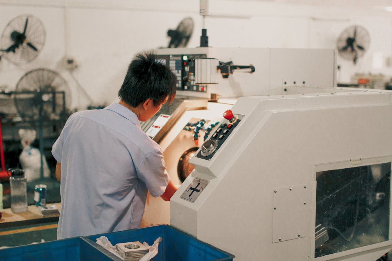 team-04 Worker focusing on operating industrial machinery in a factory setting.